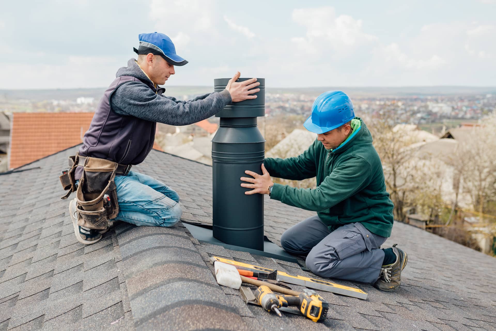 Team repairing a chimney stack on a residential roof